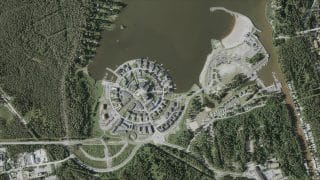Foto tagen högt uppifrån av Sjötullens område. Mitt på fotot det cirkelformade bostadsmässområdet från år 2011 som sträcker sig ända till havet. Bredvid syns Havsparken med sin campingplats och sandstränder. Till höger på bilden syns Sundet som rinner ut i havet, längs det båthus samt hamnkajen där Sundet slutar.