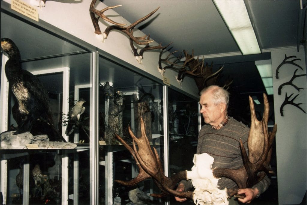 Salkio holds an antler of an elk in his hand.