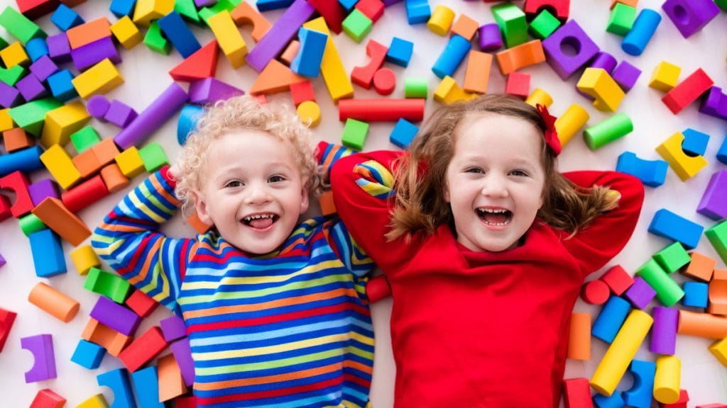 Two kids and colorful toys
