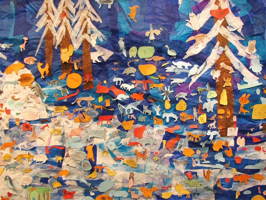 Children have drawn animals that have been fastened to wintery scene made of silk paper.