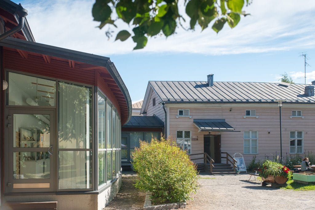 Kieppi from outside with doors of the old wooden building open to visitors.