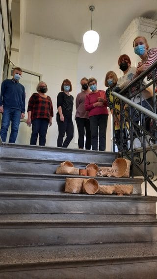 Tuohityökurssilaisten yhteiskuva ja heidän valmistamiaan tuotteita.