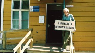 Veikko Salkio is holding a sign of Strict Nature Reserve of Pummanki in the front of Kieppi in the beginning of 2000's.