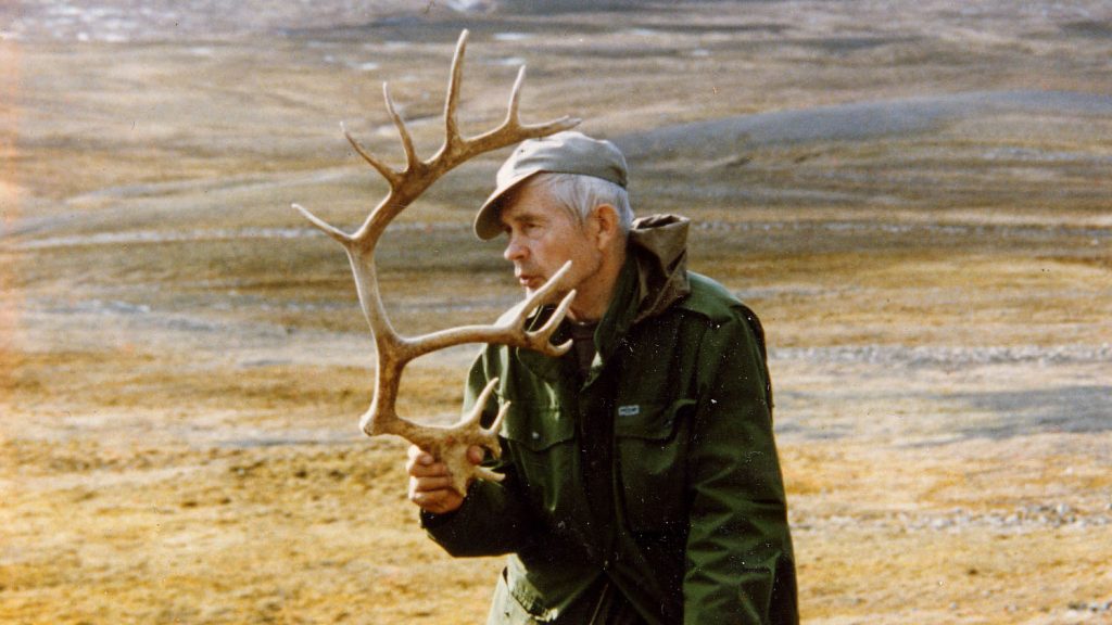 Salkio holds a cast antler in his hand fell scenery behind.