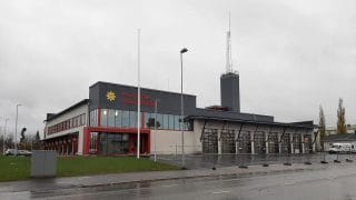 Karleby brandstation, som blev färdig år 2021, sett framifrån. I bakgrunden syns en himmel som är täckt av gråa regnmoln.